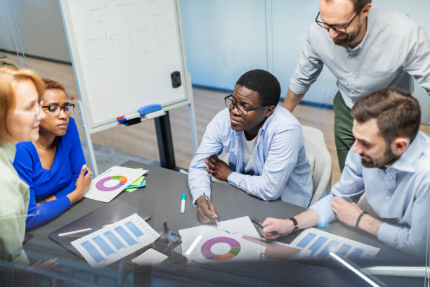 istock Business team working on new project using laptops, white board, diagrams 2168382507