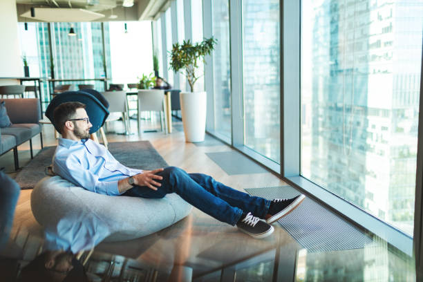 Relaxed businessman working sitting in bean bag