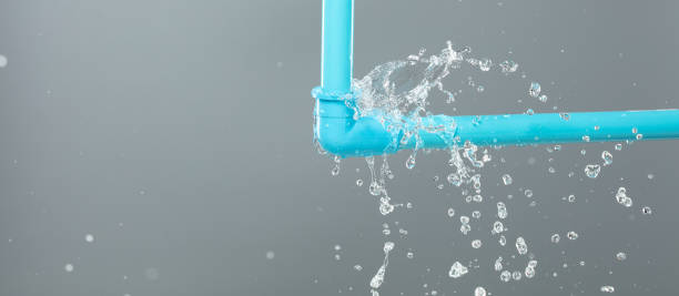istock Leaking water from blue pvc plastic pipe under sink. Drain leak water from blue pvc plastic pipe broken connection plumbing in bathroom. Gray background isolated 2168383772