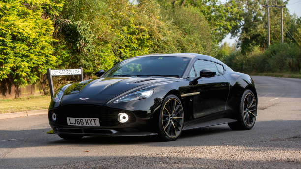Whittlebury,Northants.,UK - Aug 25th 2024: 2017 black Aston Martin Vanquish car driving on a British country road.