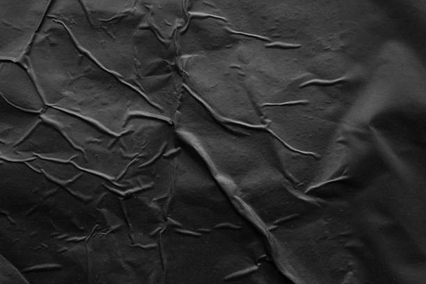 istock black crumpled and creased plastic poster texture background 2168385064