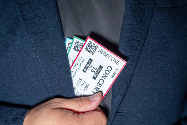 istock Close-up of a hand taking three tickets from a pocket,Ticket Scalping concept 2168385920