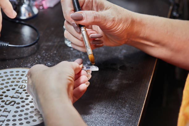 istock Nail Technician Applying Gel to Nail 2168387863