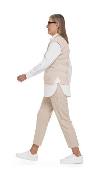 istock Senior woman in glasses walking on white background 2168387912