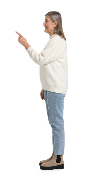 istock Senior woman pointing at something on white background 2168388374