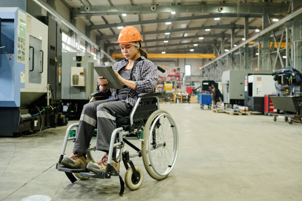 istock Checking Blueprints on Tablet in Wheelchair in Factory 2168390000