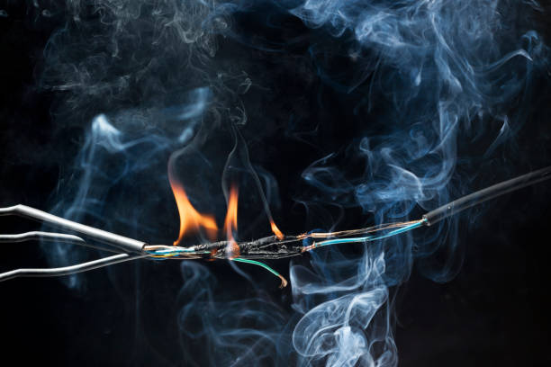 istock Flames from electric shocks Short-circuited cables cause sparks, explosions, excessive power usage, damaged and non-standard equipment.  on a dark black background 2168391466