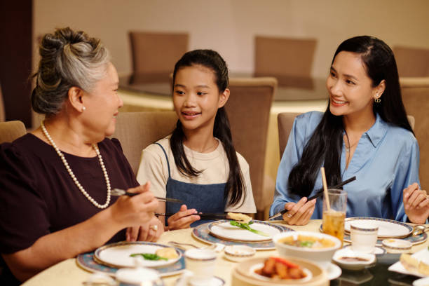 istock Family Talking At Dinner At The Restaurant 2168398562