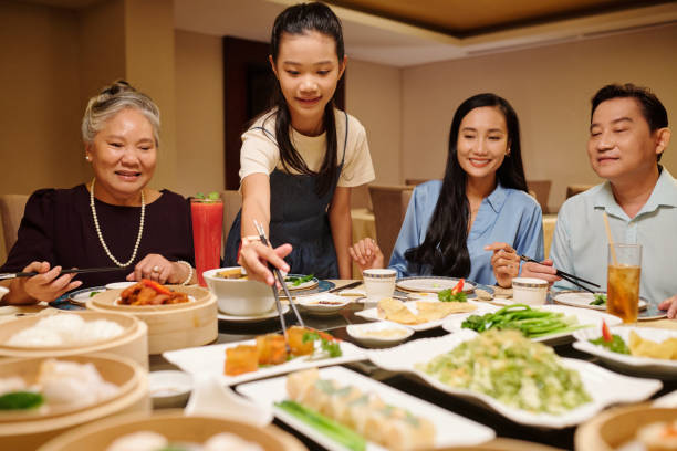 istock Family Eating Rolls In The Restaurant 2168398577