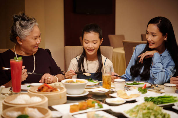 istock Girl Having Dinner With Family 2168398578