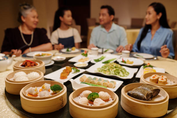 istock Family Sitting At Dining Table With Various Dishes 2168398630