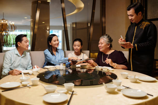 istock Waiter Taking Order From Family 2168398915