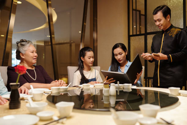 istock Family Reading Menu And Making Order 2168399046
