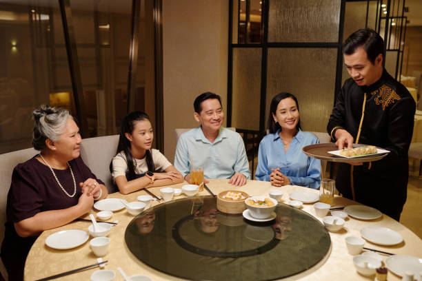 istock Waiter Serving People In The Restaurant 2168399165
