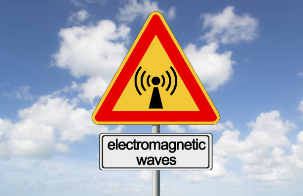 ALERT ABOUT ELECTROMAGNETIC POLLUTION EXPOSURE - Concept with warning indicator sign against a cloudy sky