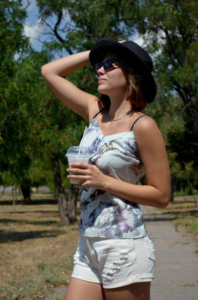 Pretty girl with milkshake in a park