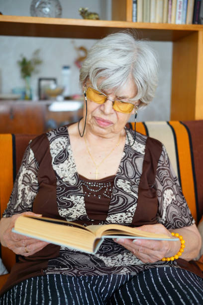 istock An Elderly Woman is Reading a Book 2168403634