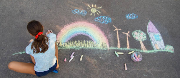 istock a child draws with chalk on the asphalt. beautiful picture. 2168404472