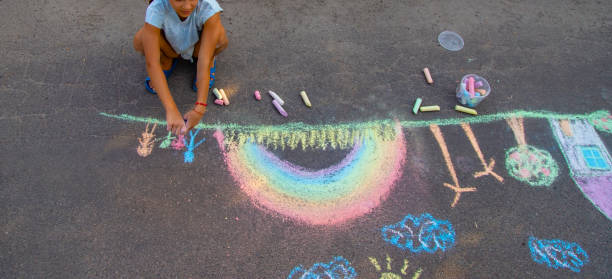istock a child draws with chalk on the asphalt. beautiful picture. 2168404476
