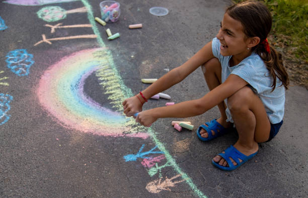 istock a child draws with chalk on the asphalt. beautiful picture. 2168404479