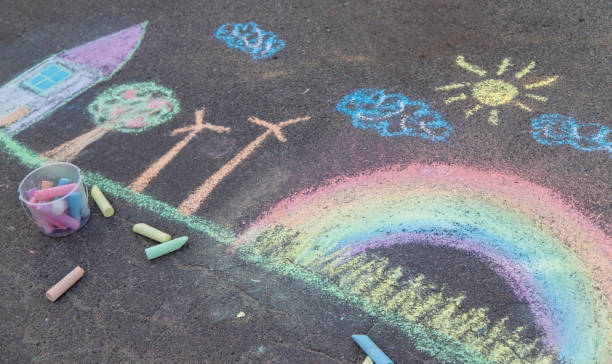 istock a child draws with chalk on the asphalt. beautiful picture. 2168404482