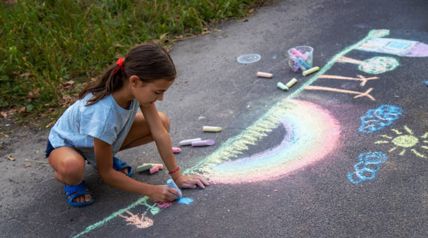 istock a child draws with chalk on the asphalt. beautiful picture. 2168404488