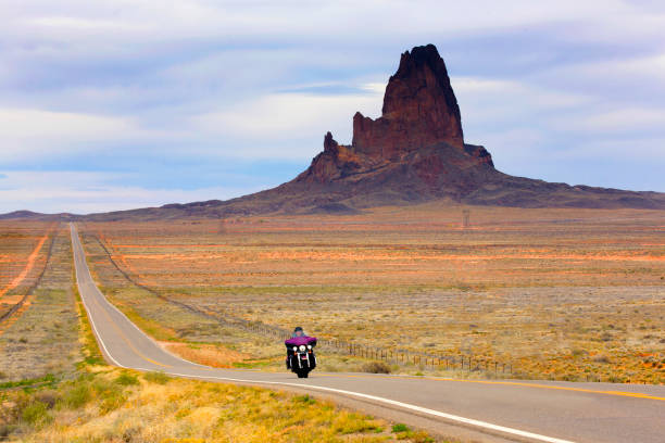istock Motorcyclist rides road below pinnacle 2168409876