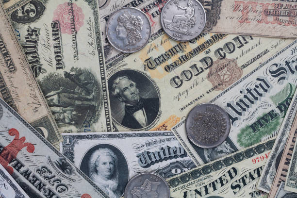 istock Old west US banknotes and silver certificates with silver dollar coins 2168409963