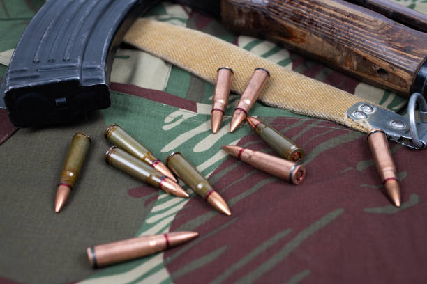istock AK assault rifle on camo uniform background 2168409993