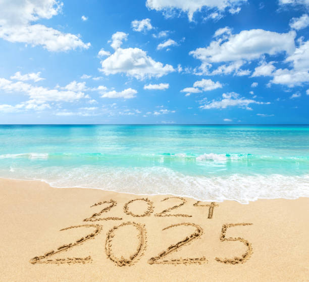 istock 2024 and 2025 on a beach sand 2168410632
