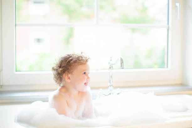 istock Baby taking bath in kitchen sink 2168412599