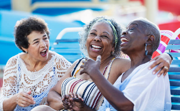 istock Three multiracial senior women on lounge chairs laughing 2168413026