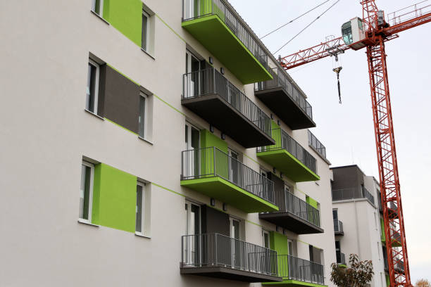 istock Modern apartment building with crane at construction site 2168424255