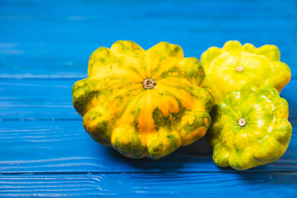 Pattypan zucchini on a textured kitchen table. squash. Fresh organic pattypan squashes on background. Vegan. Farmer's Market. Patisson. Space for text. Copy space.