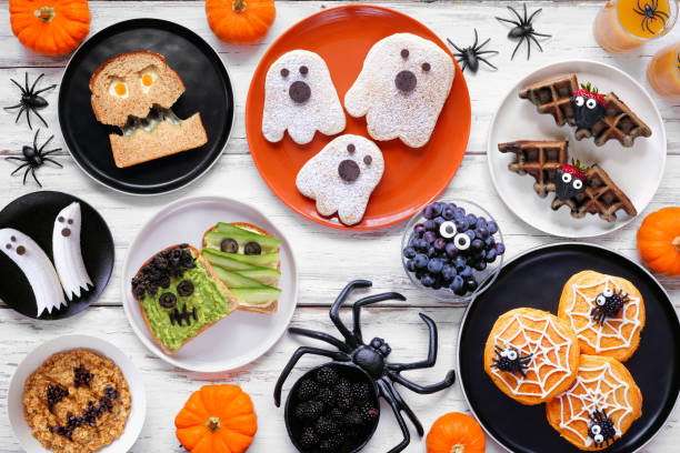 istock Spooky Halloween breakfast table scene over a white wood background 2168430370