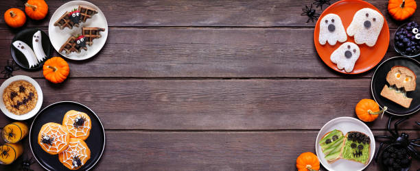 istock Spooky Halloween breakfast double border over a dark wood banner background 2168430391