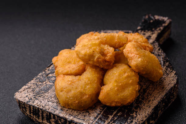 istock Delicious fresh crispy chicken nuggets on a dark concrete background 2168431824