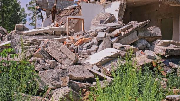 istock Abandoned Collapsed Ruined Building with Concrete and Cinderblock Rubble Destroyed in Controlled Demolition or Natural Disaster Hurricane Tornado or War Bomb Raid 2168431982