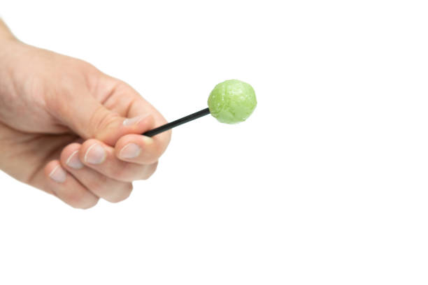 Male hand holding lollipop isolated on white background