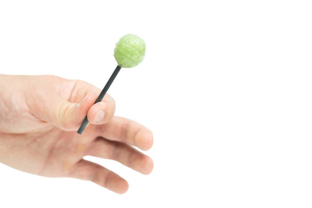 Male hand holding lollipop isolated on white background