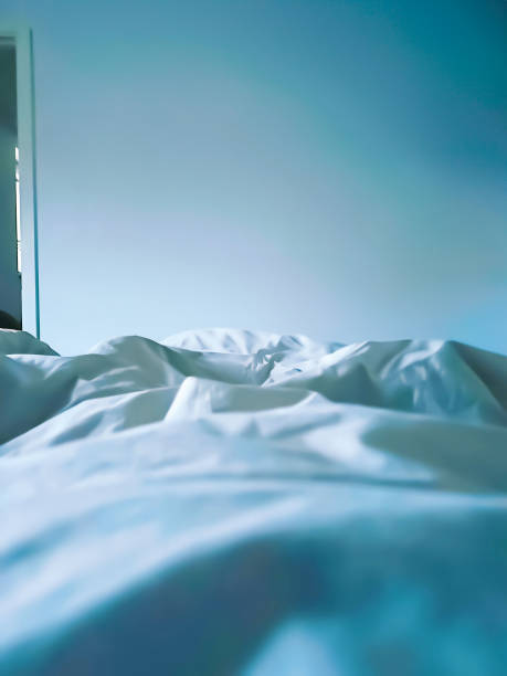Close up empty bed and unmade at the first light of dawn. High quality photo