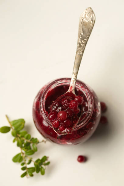 istock A small jar of lingonberry wild berries, top view 2168436601