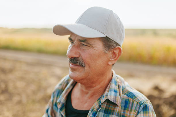 istock Old Man Farmer with Mustache Poses in Field 2168440128