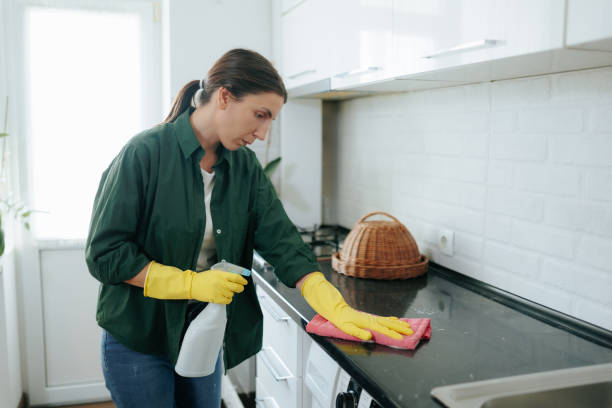 istock Young Woman at Home, Cleaning Kitchen Table with Gloves 2168441827