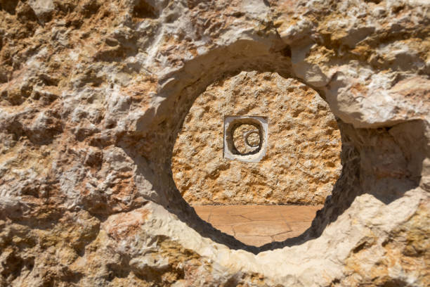 The rough texture of the Jerusalem stone, with an orange tint, is photographed from the front in close-up on a clear, sunny day,  natural background.