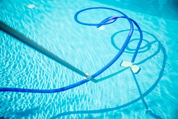 istock Cleaning swimming pool with an automatic pool cleaner 2168446857