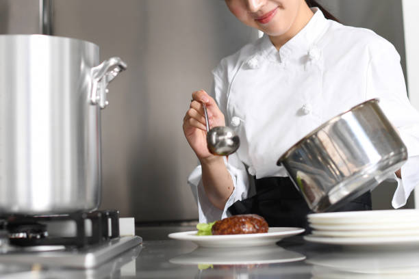 Close-up of chef preparing food in commercial kitchen