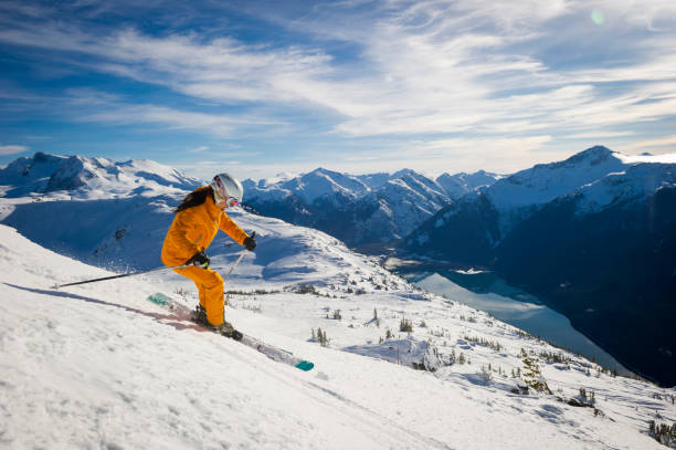 Woman skis groomed runs at ski resort Woman skis groomed runs at ski resort, Whistler, B.C. pacific northwest region stock pictures, royalty-free photos & images