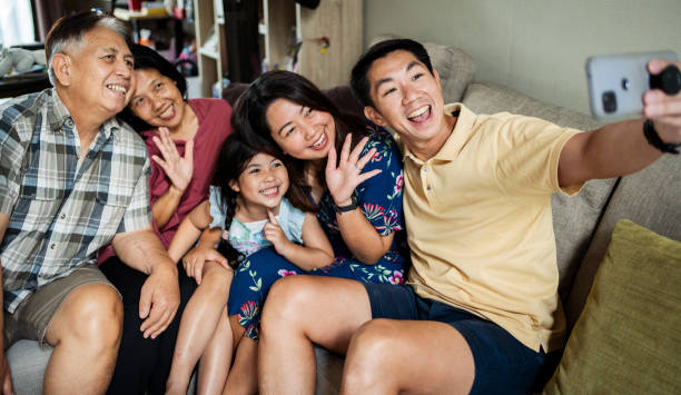 istock Happy multi-generation family taking selfie together at home 2168452650