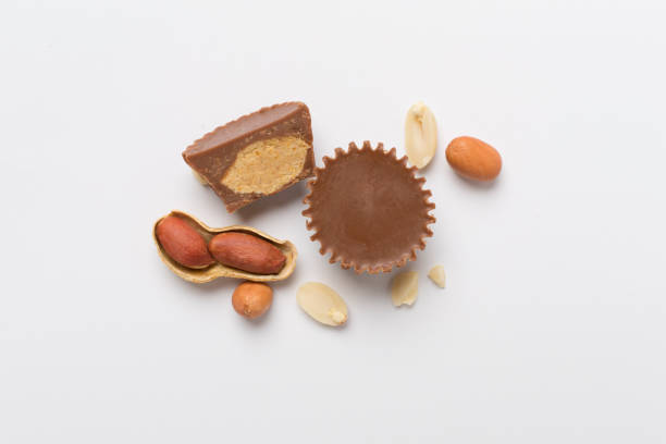 istock Tasty chocolate peanut butter cups on color background, top view 2168453998